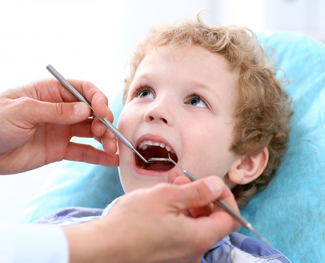 Child getting a cleaning - importance of dentist
