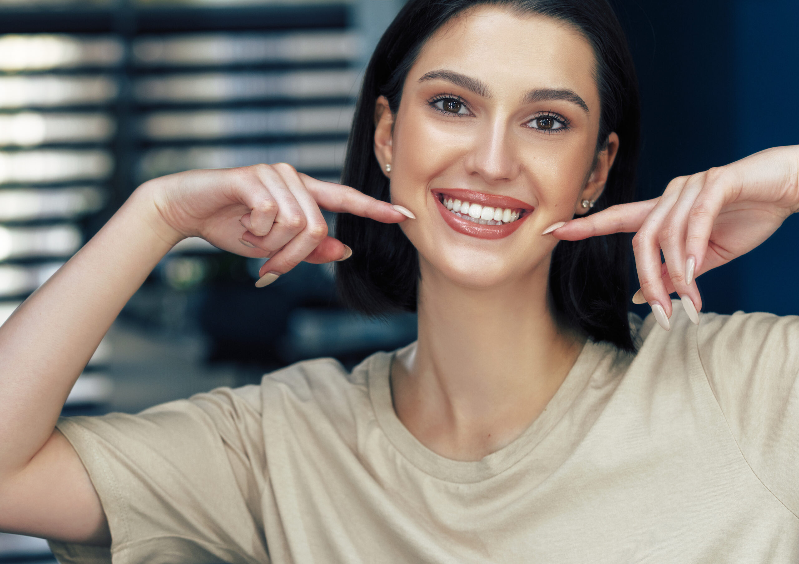 Woman smiling after visiting the dentist office. Dental credit concept image.
